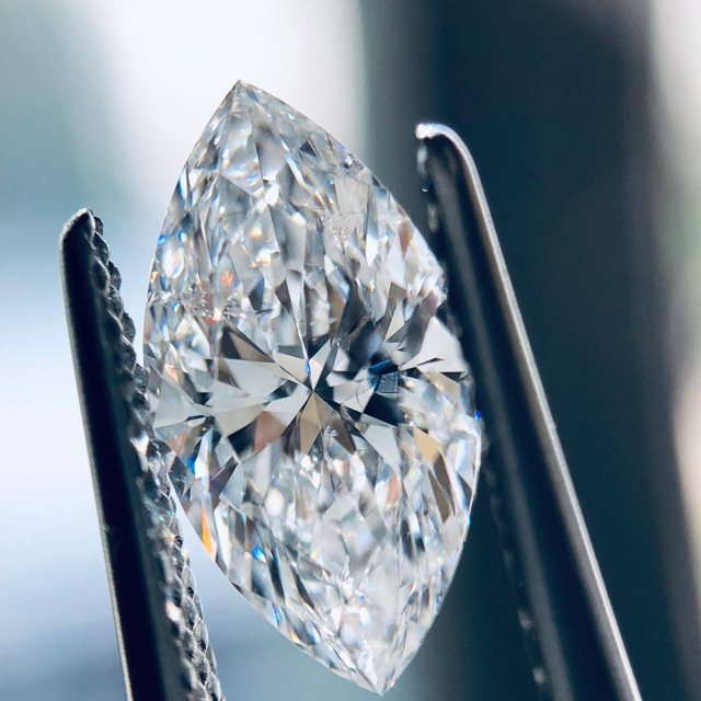 Marquise-cut loose diamond held in tweezers